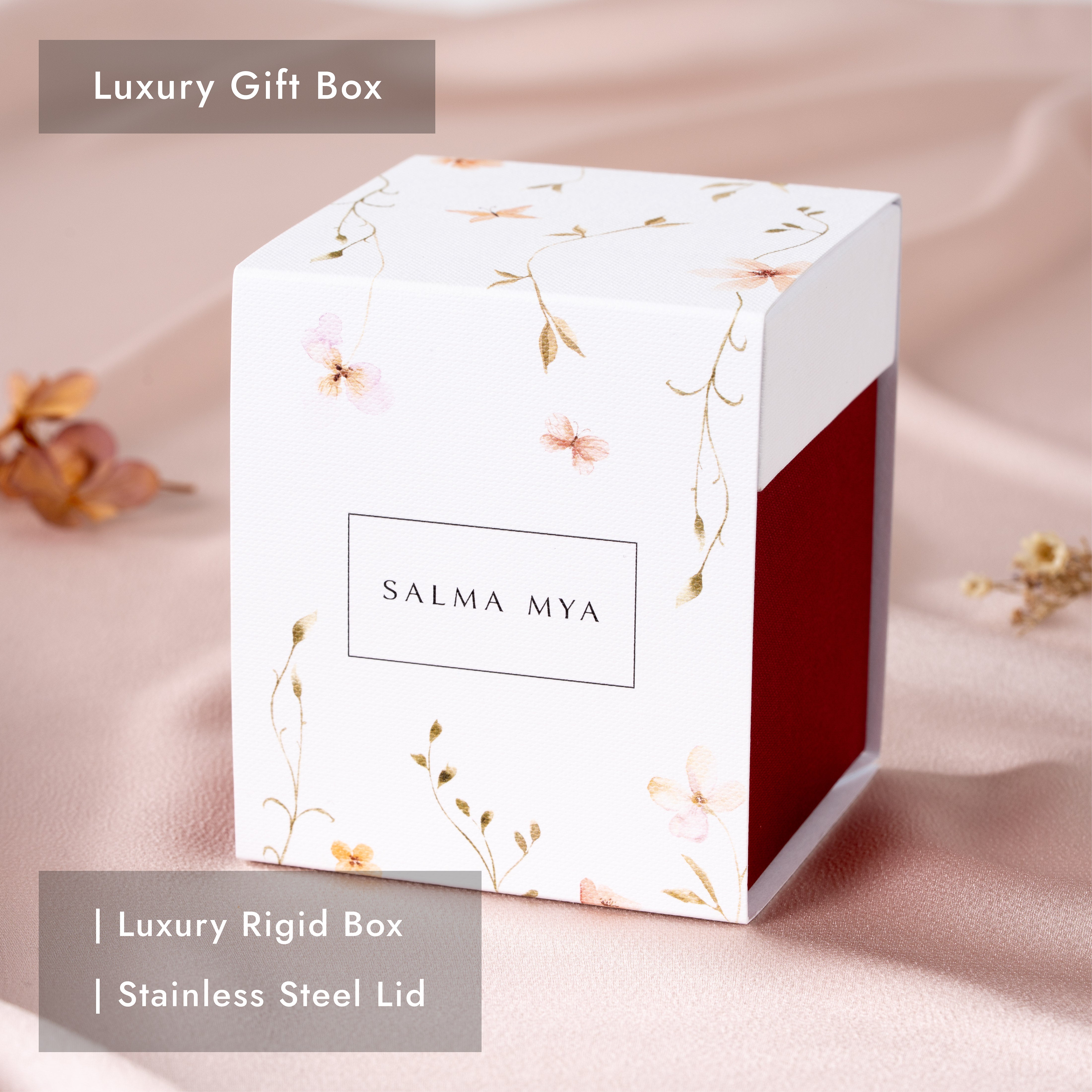 Luxury deep red rigid gift box with a white floral printed sleeve and SALMA MYA logo, shown closed
