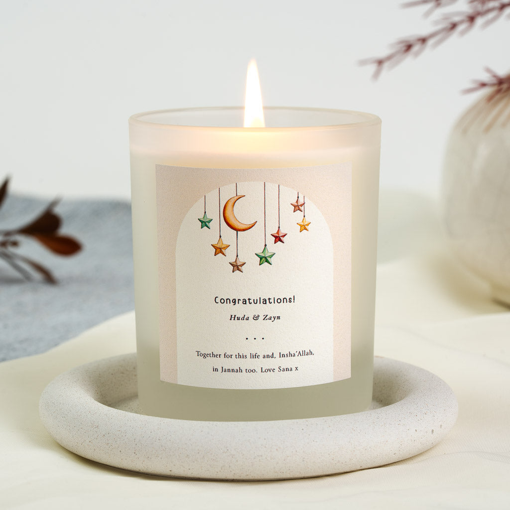 Personalised Islamic wedding candle with a crescent moon and coloured stars hanging in an arch
