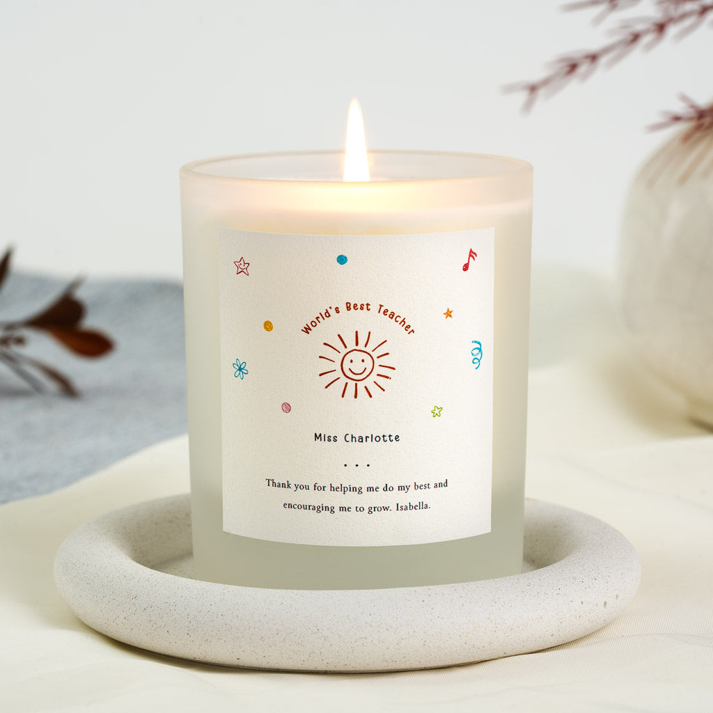 Smiling sun with scattered doodles above an arched heading on a personalised teacher candle