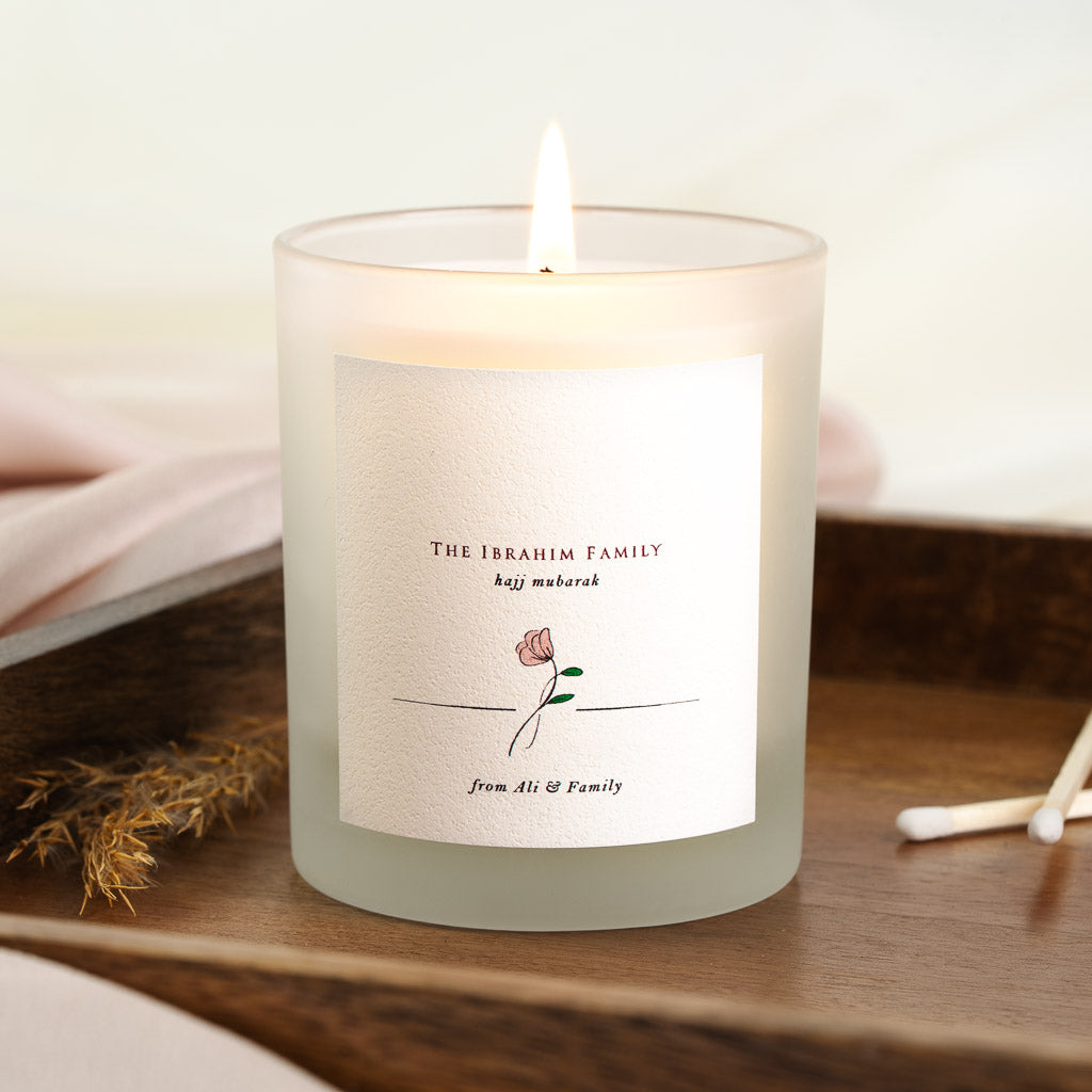 Personalised Hajj candle with the family name above a line-drawn rose