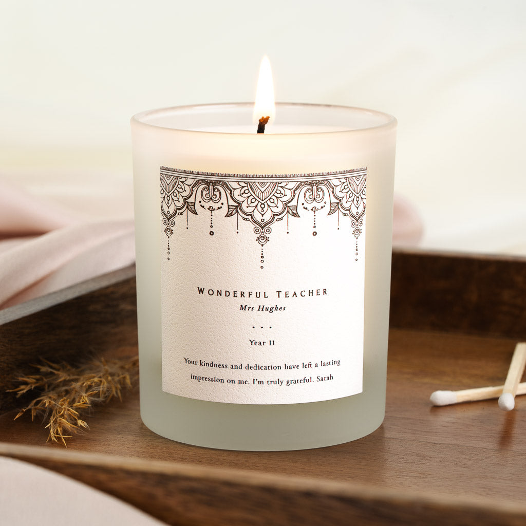 Ornate henna-style lace border across the top of a personalised teacher candle label