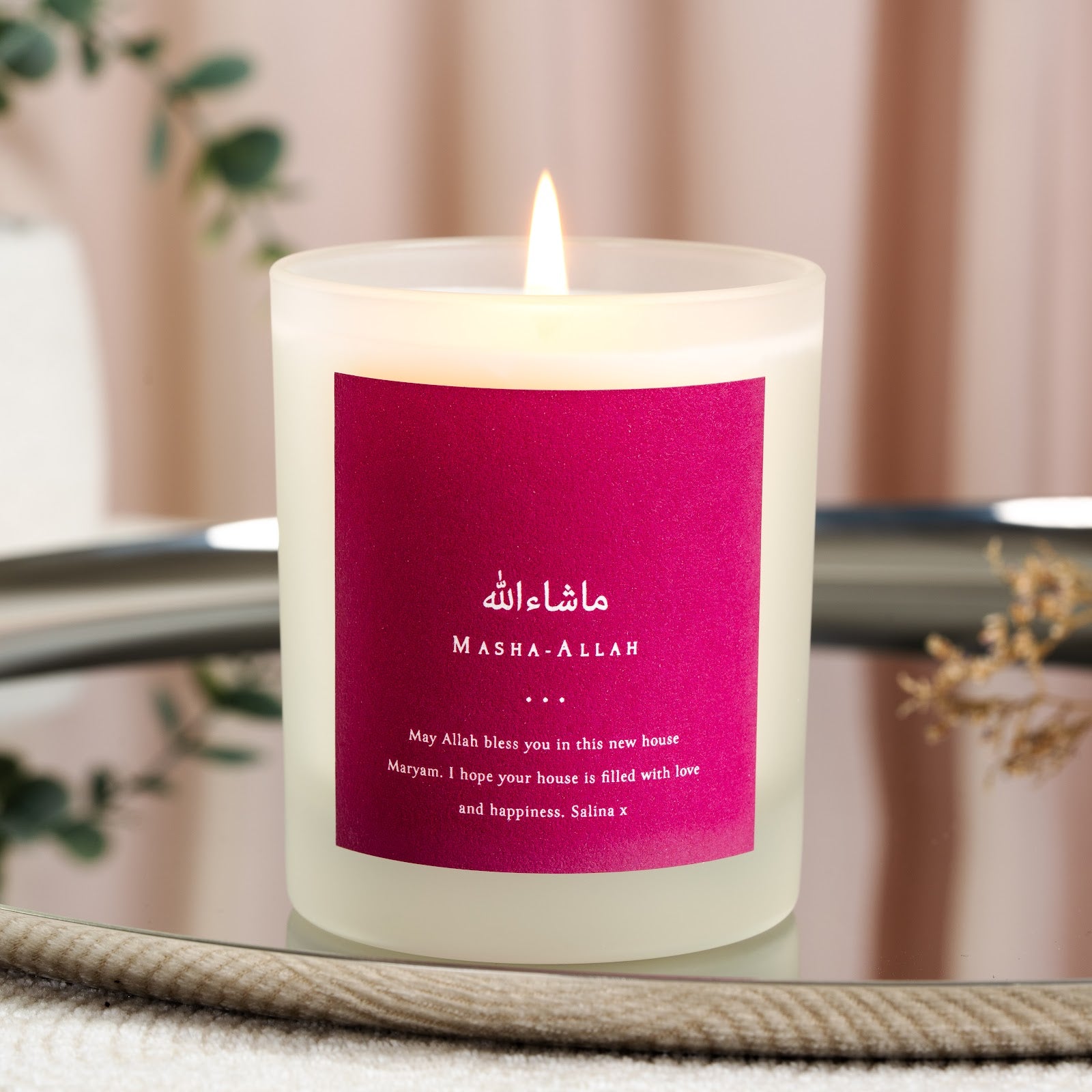 Personalised Islamic new home candle with white Arabic script on a magenta background