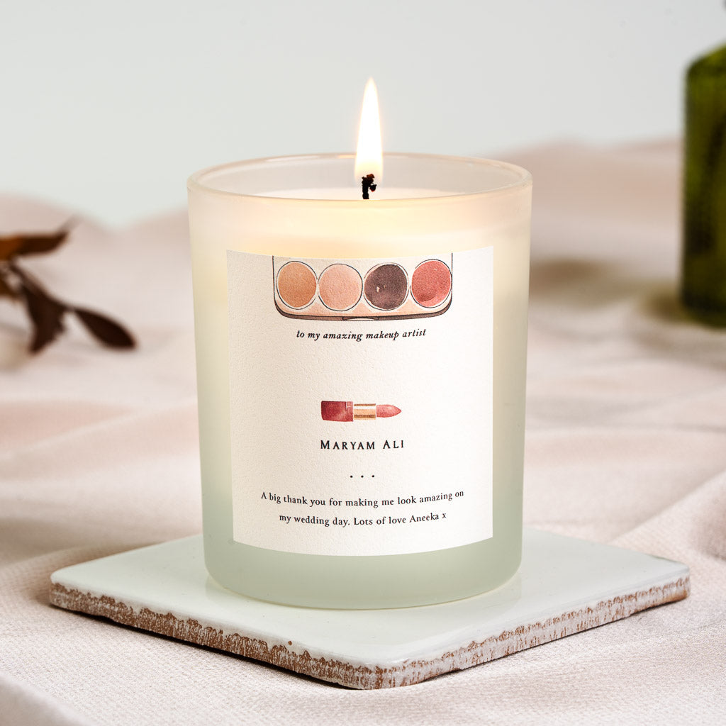 Watercolour eyeshadow palette and lipstick illustration on a personalised thank you candle