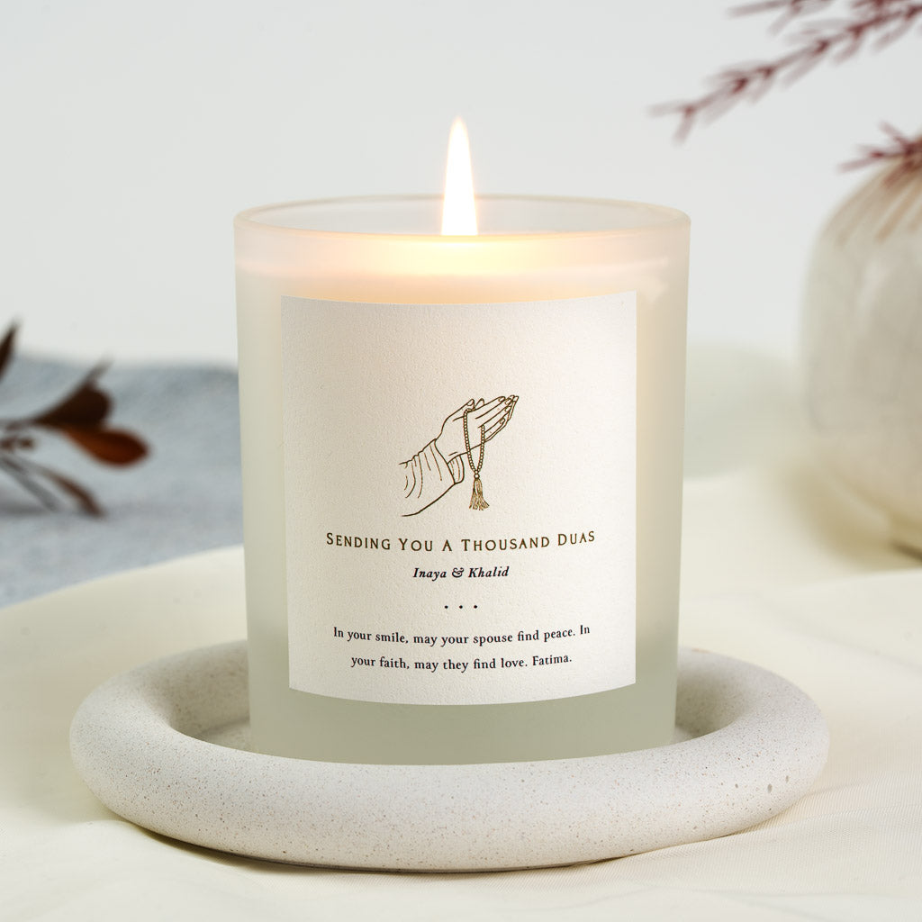 Personalised nikah candle with a gold line hand holding prayer beads