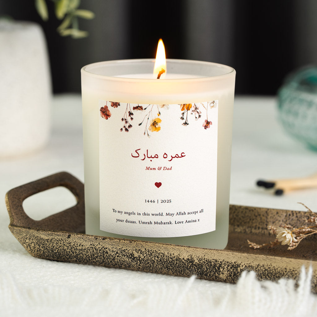 Personalised Umrah candle with an Arabic greeting beneath a dusty pink floral border