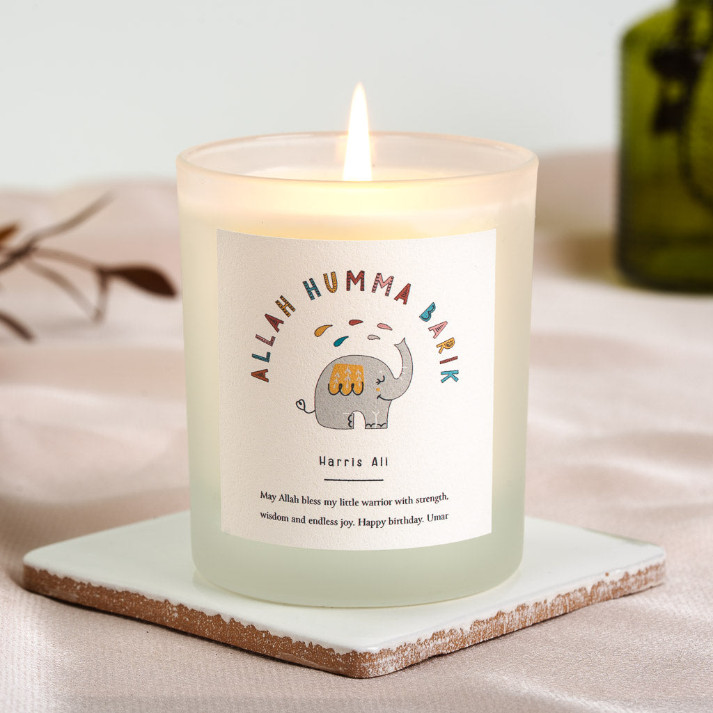 Grey elephant beneath an arcing blessing in mixed colours on a personalised birthday candle