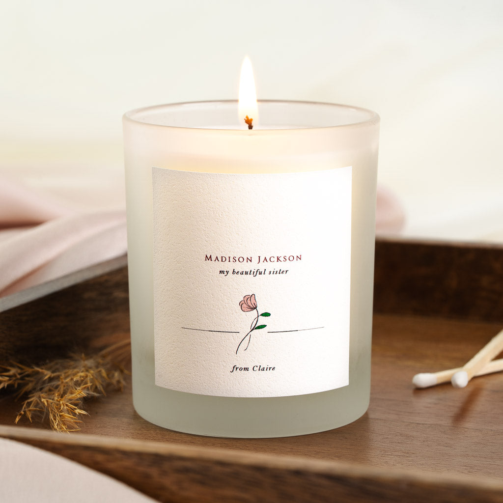 Minimalist personalised wedding candle with a single flower and the chosen relationship line
