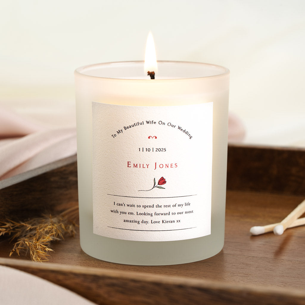 Personalised wedding day candle with a single red tulip beneath curved red lettering
