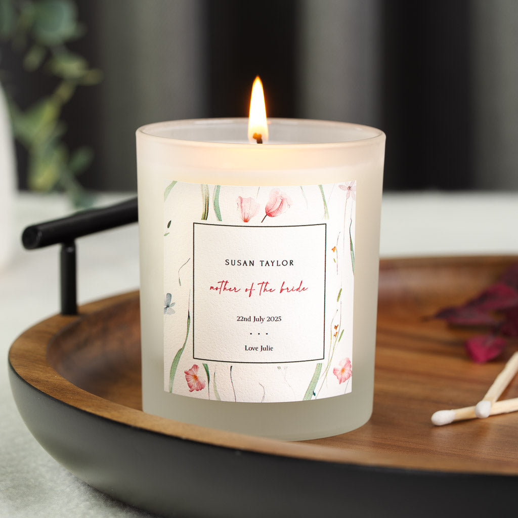 Pink and blue watercolour flowers trailing around a personalised mother of the bride candle