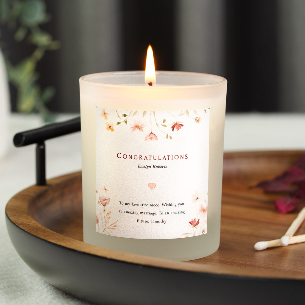 Personalised wedding congratulations candle with serif lettering on a plain soft white label