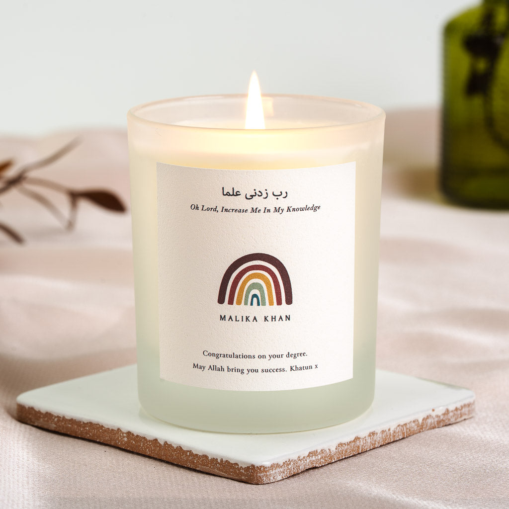 Arabic dua above its English translation and a small rainbow on a personalised candle