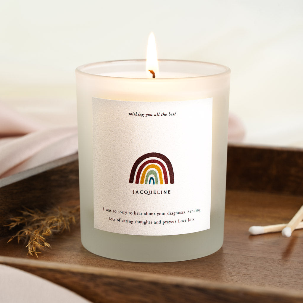 Personalised get well candle with a muted rainbow beneath an italic well-wish