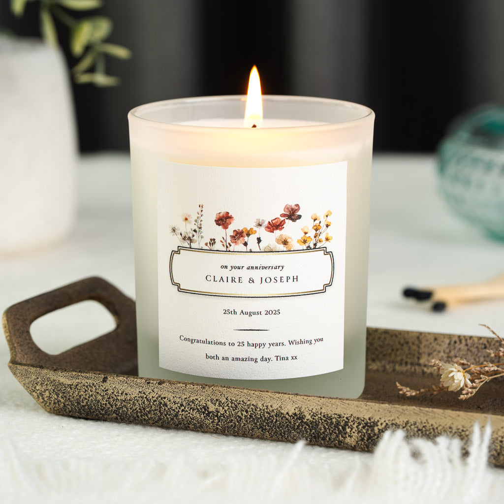 Personalised anniversary candle with a wildflower meadow border around the names