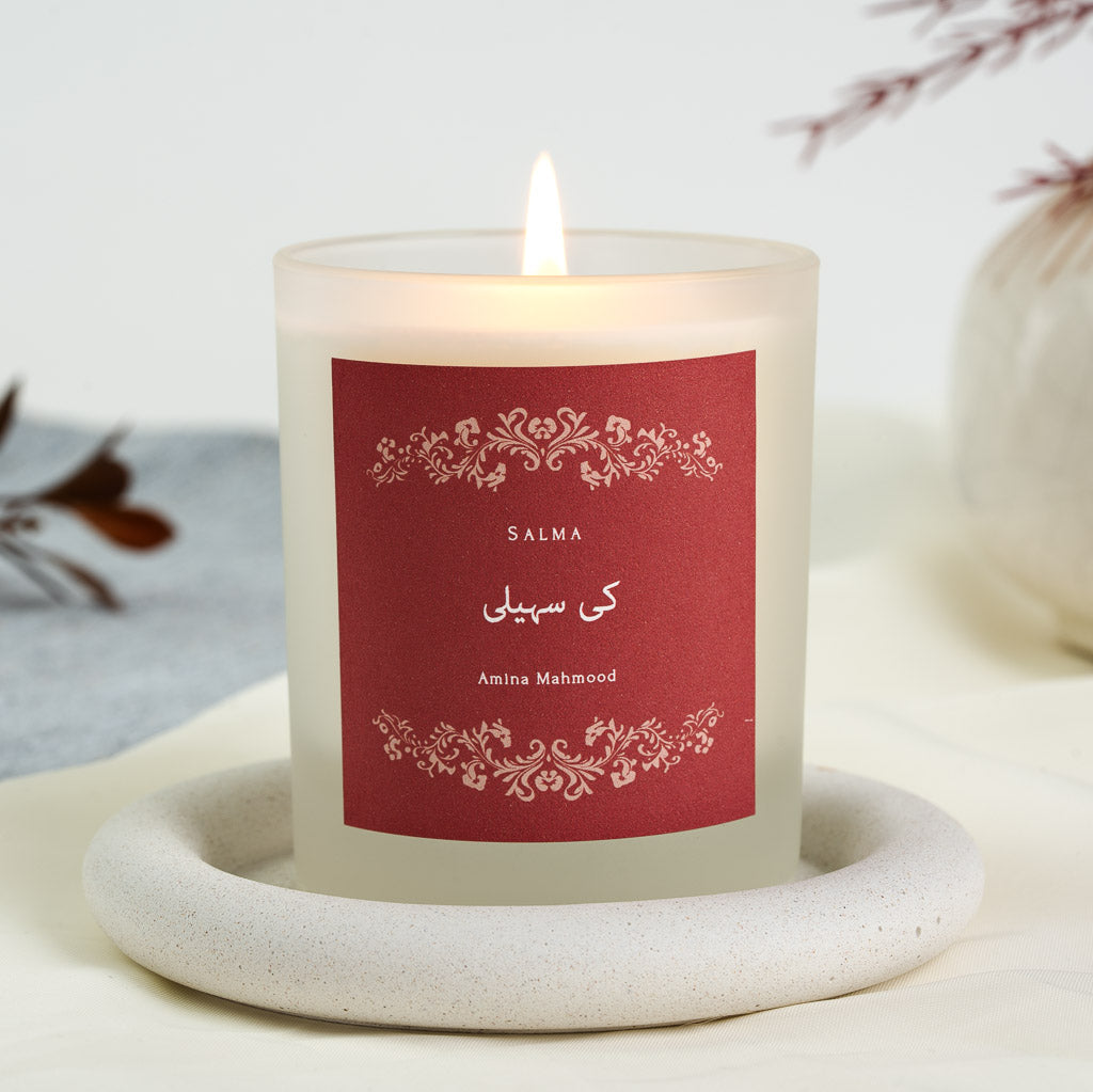 Personalised bridesmaid candle with a pale cream floral border on a deep red label
