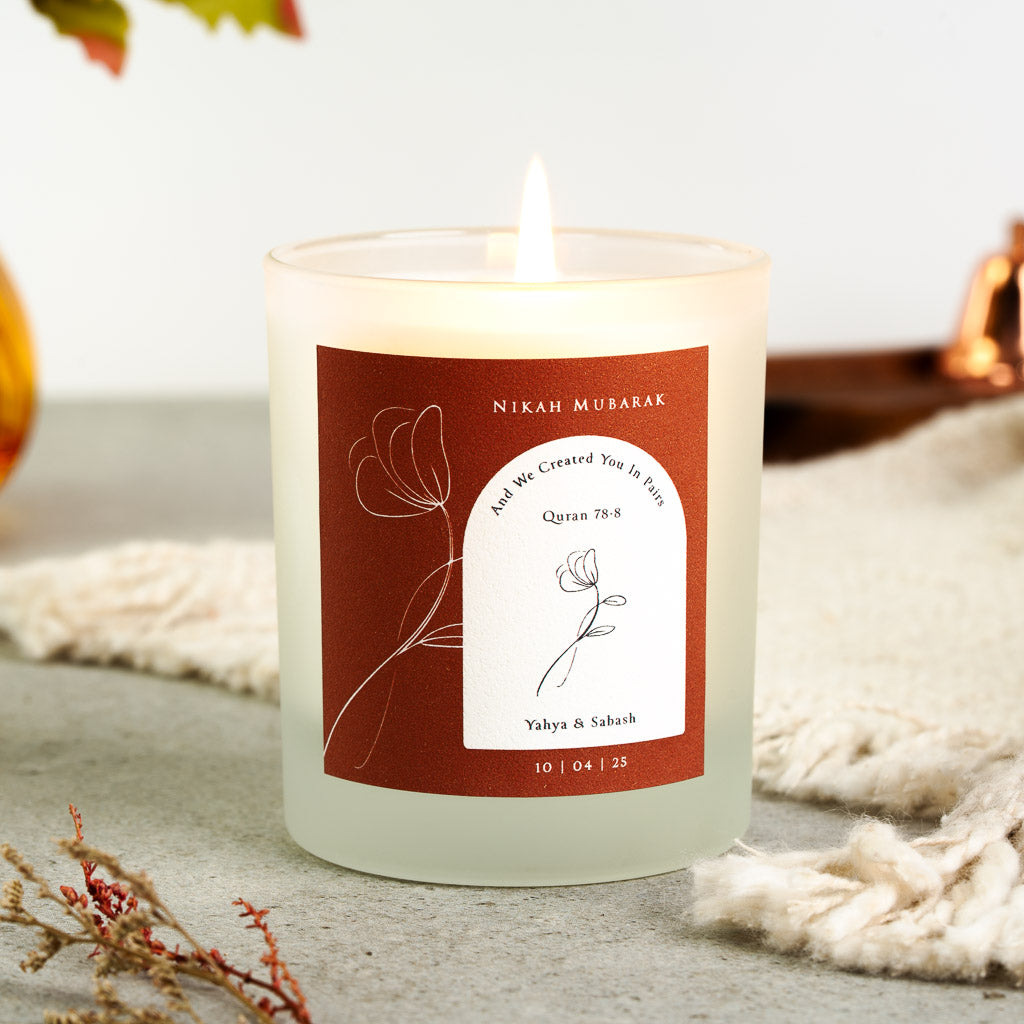Single-line floral illustration and Surah An-Naba on a rust personalised nikah mubarak candle