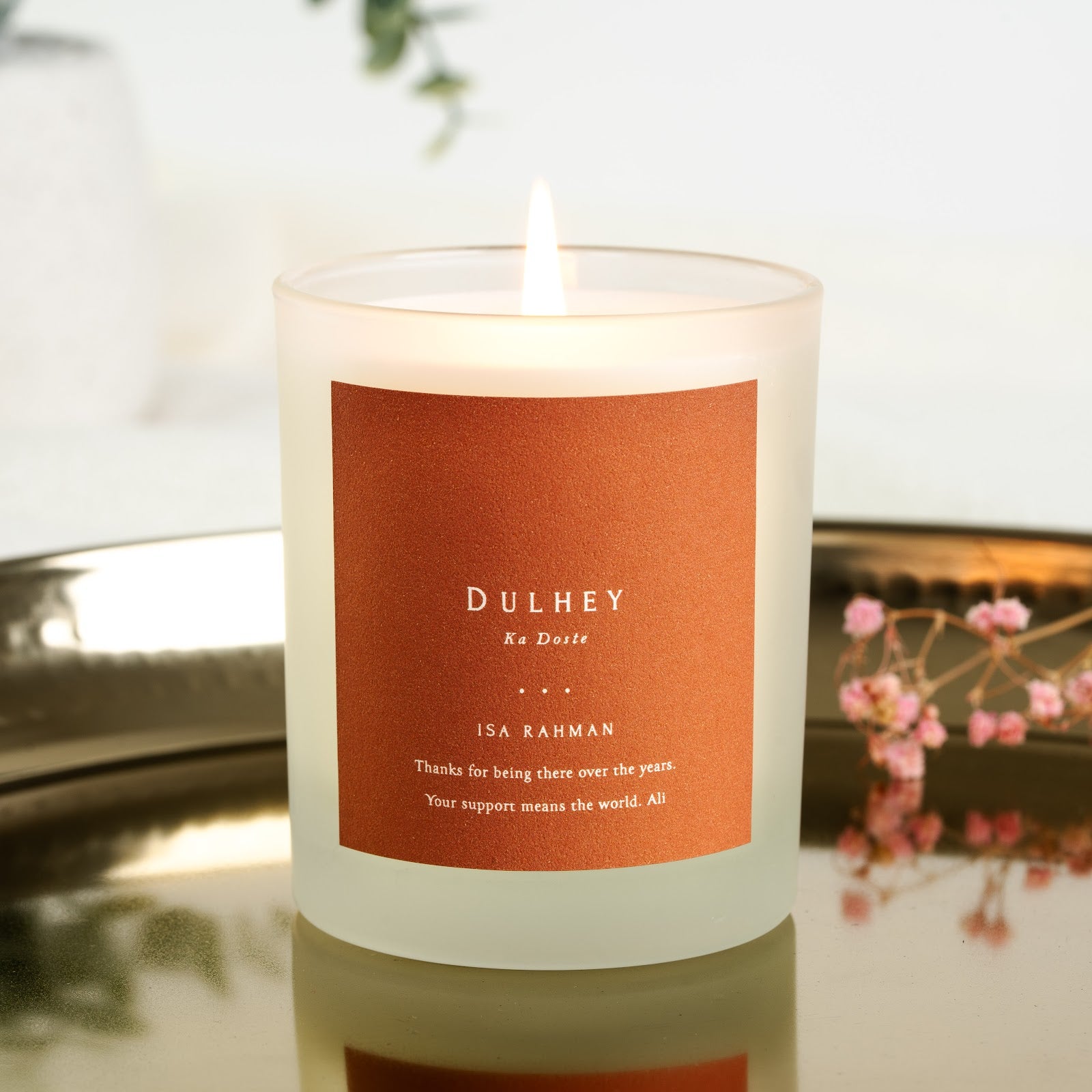 Dulhey Ka Doste in white capitals on a solid burnt orange personalised groomsman candle