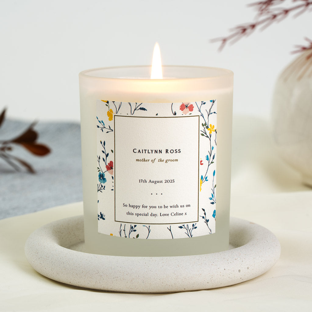 Pressed-style flower border around a panel on a personalised mother of the groom candle