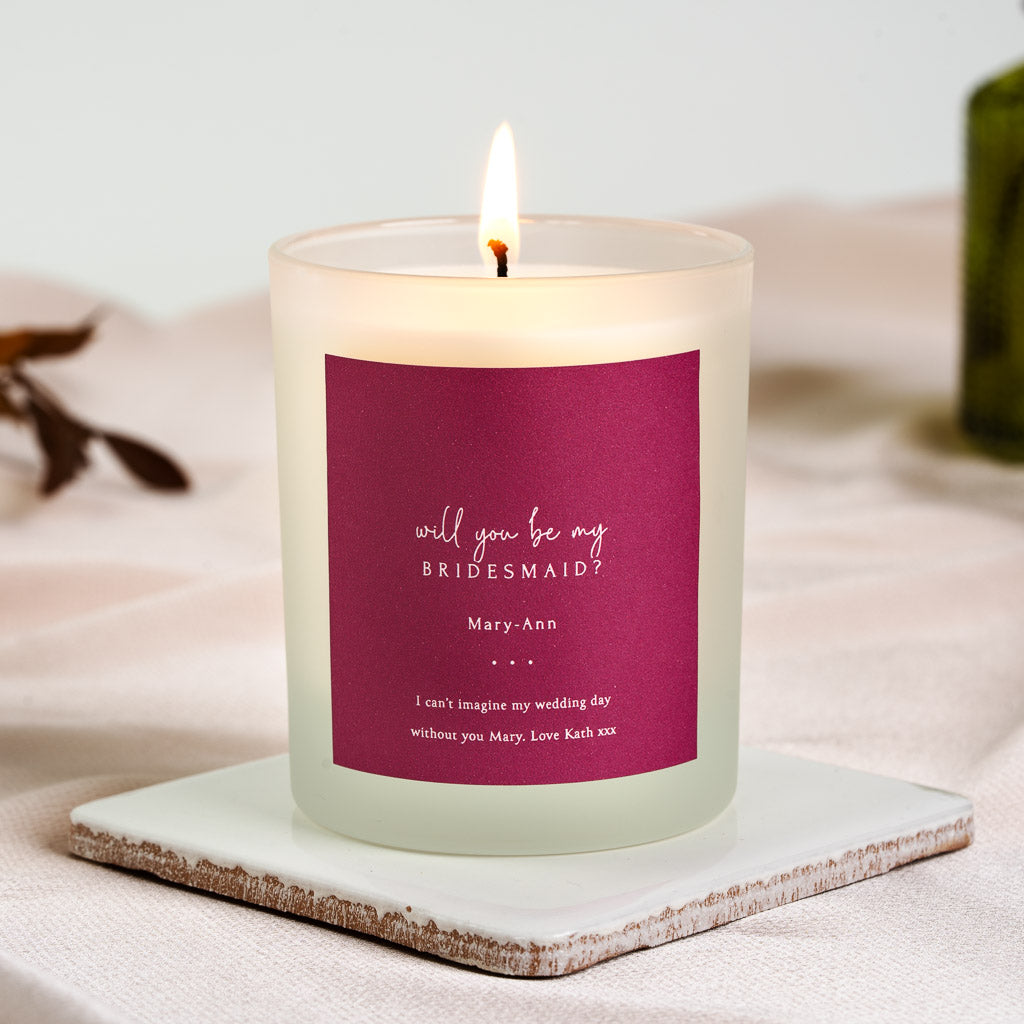 White script on a deep berry pink personalised bridesmaid proposal candle label