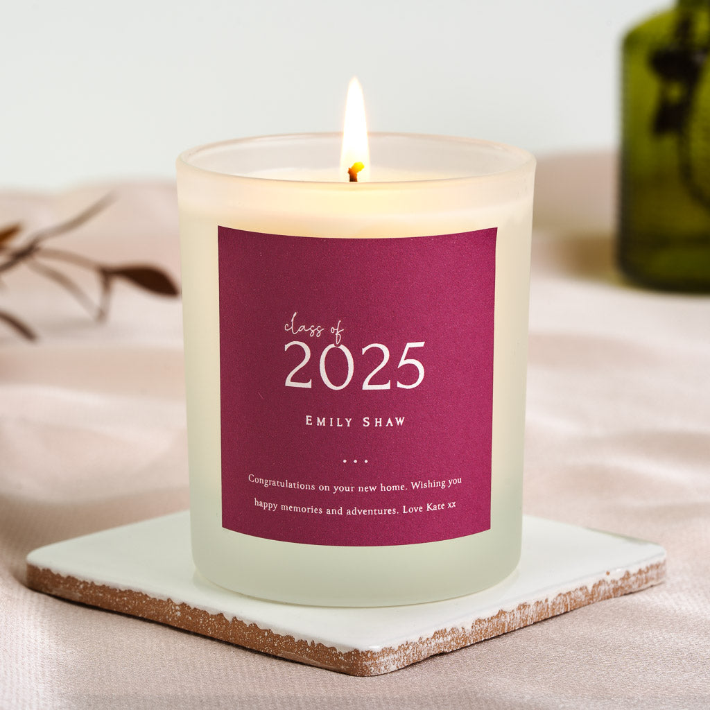 Personalised graduation candle with the year in oversized white numerals on deep berry pink