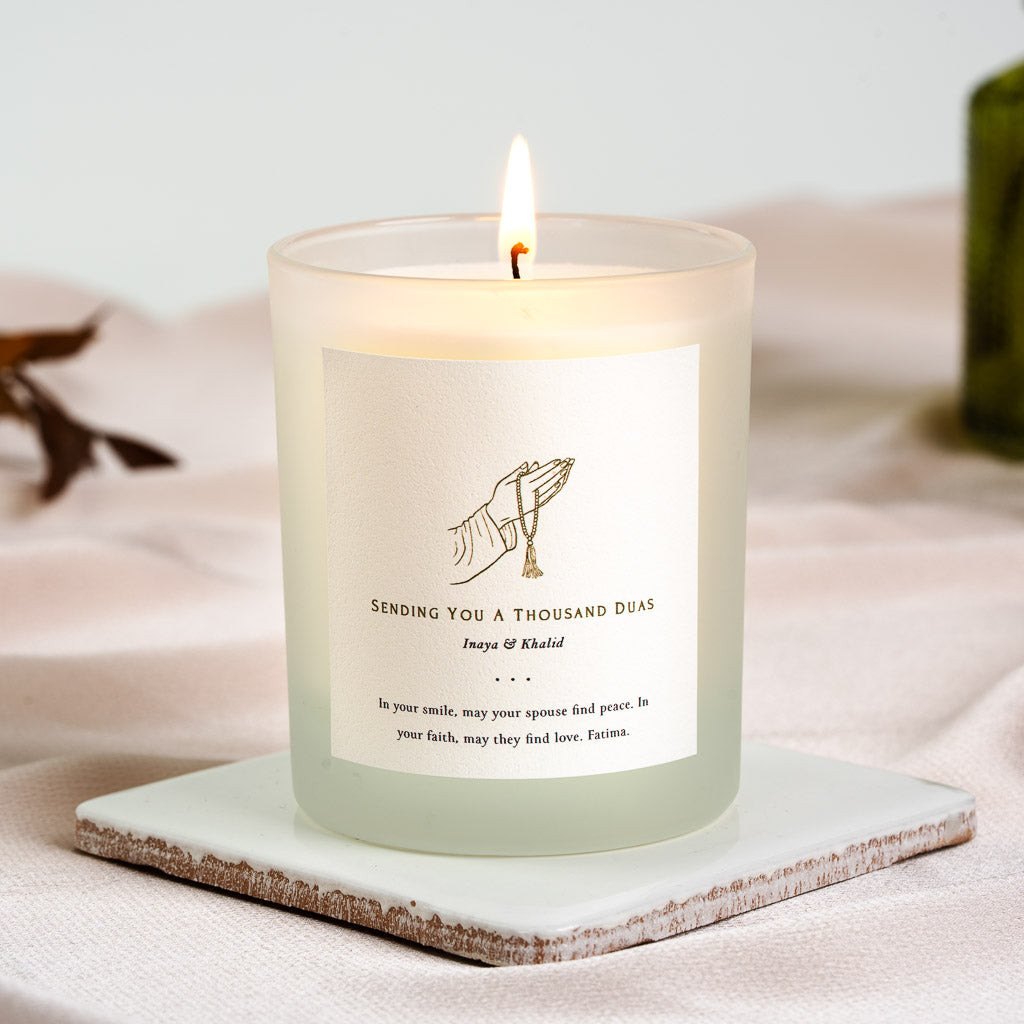 Personalised Islamic wedding candle with a hand holding a string of prayer beads