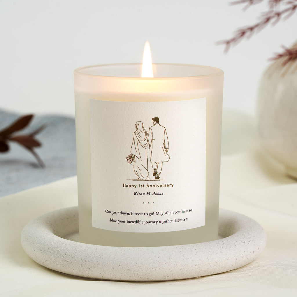 Line drawing of a couple walking away, the wife in a hijab, on a personalised anniversary candle