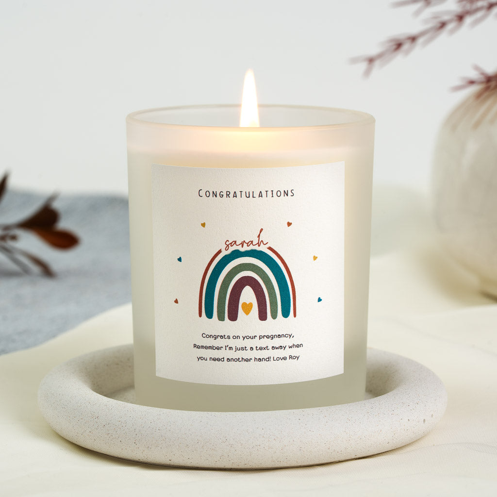 Personalised congratulations candle with a rainbow beneath an arched red script name