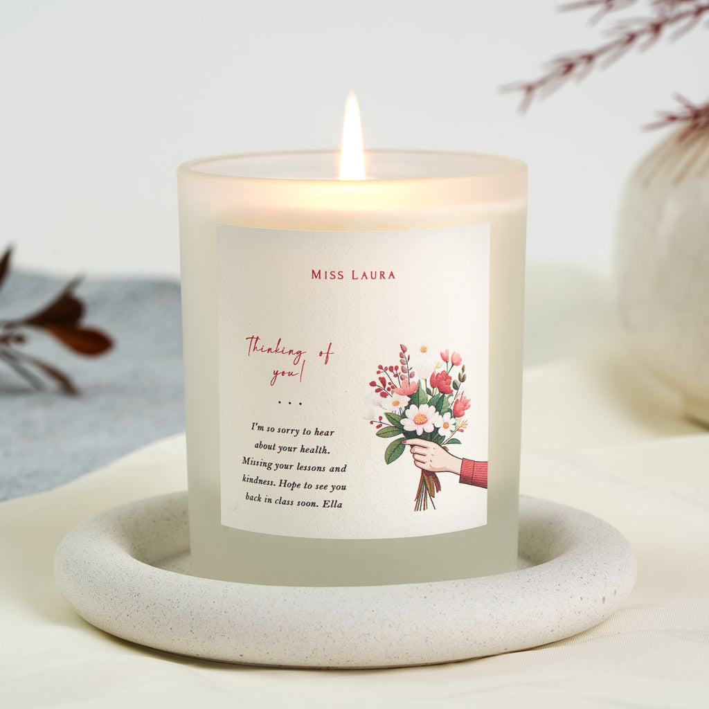 Personalised get well soon candle with an outstretched arm holding a pink and red bouquet