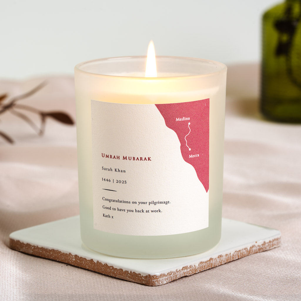 Red map panel marking Medina and Mecca on a personalised Umrah candle label