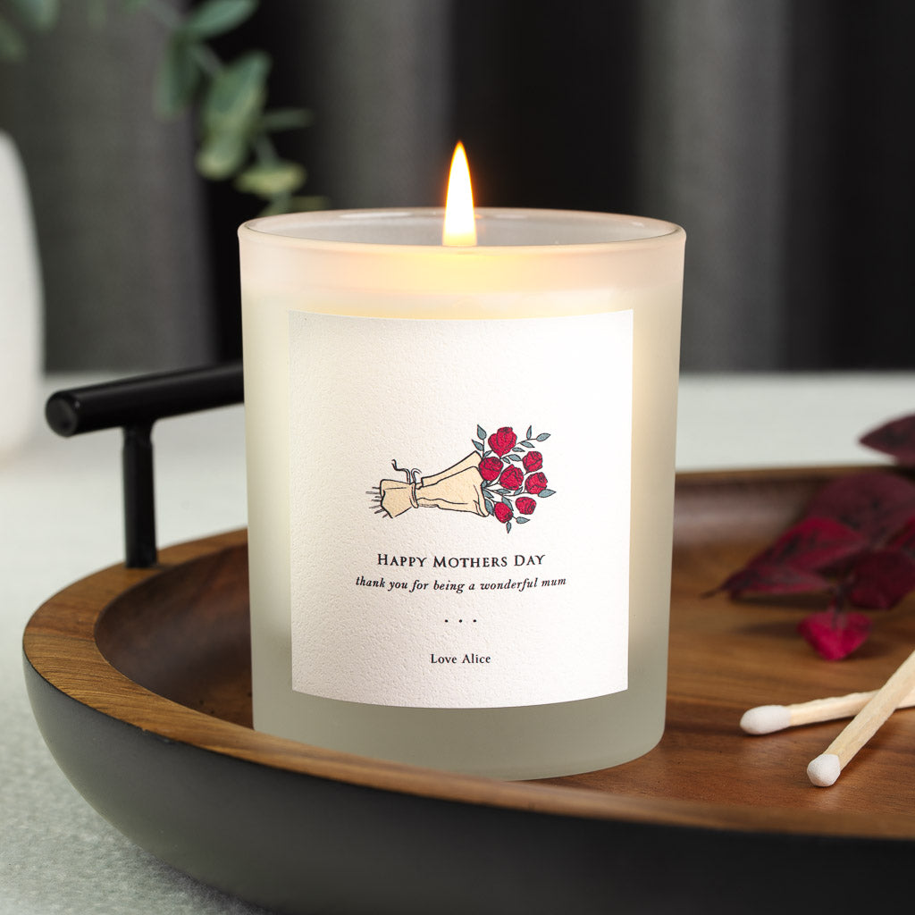 Personalised Mother's Day candle with a bold script initial over a pale grey sprig