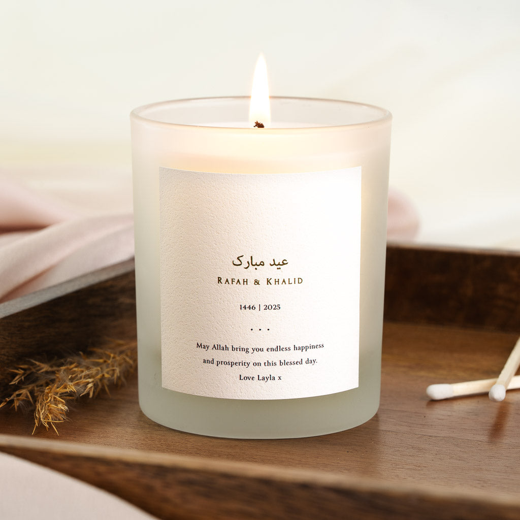 Arabic Eid Mubarak greeting in fine gold script on a personalised candle label