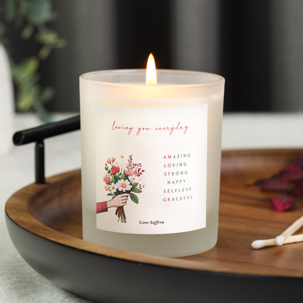Personalised Mother's Day candle with an acrostic running beside a hand-held bouquet