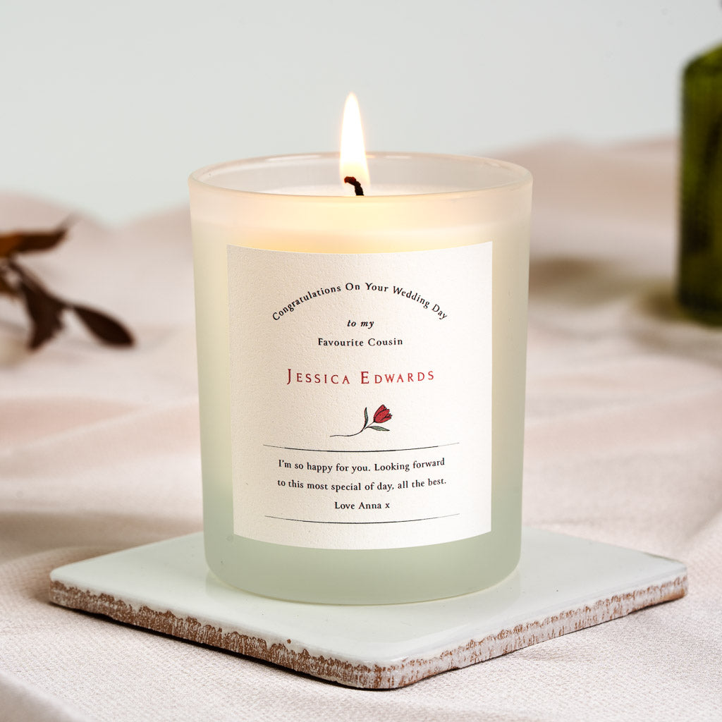Curved header above a message framed between two rules on a personalised wedding candle