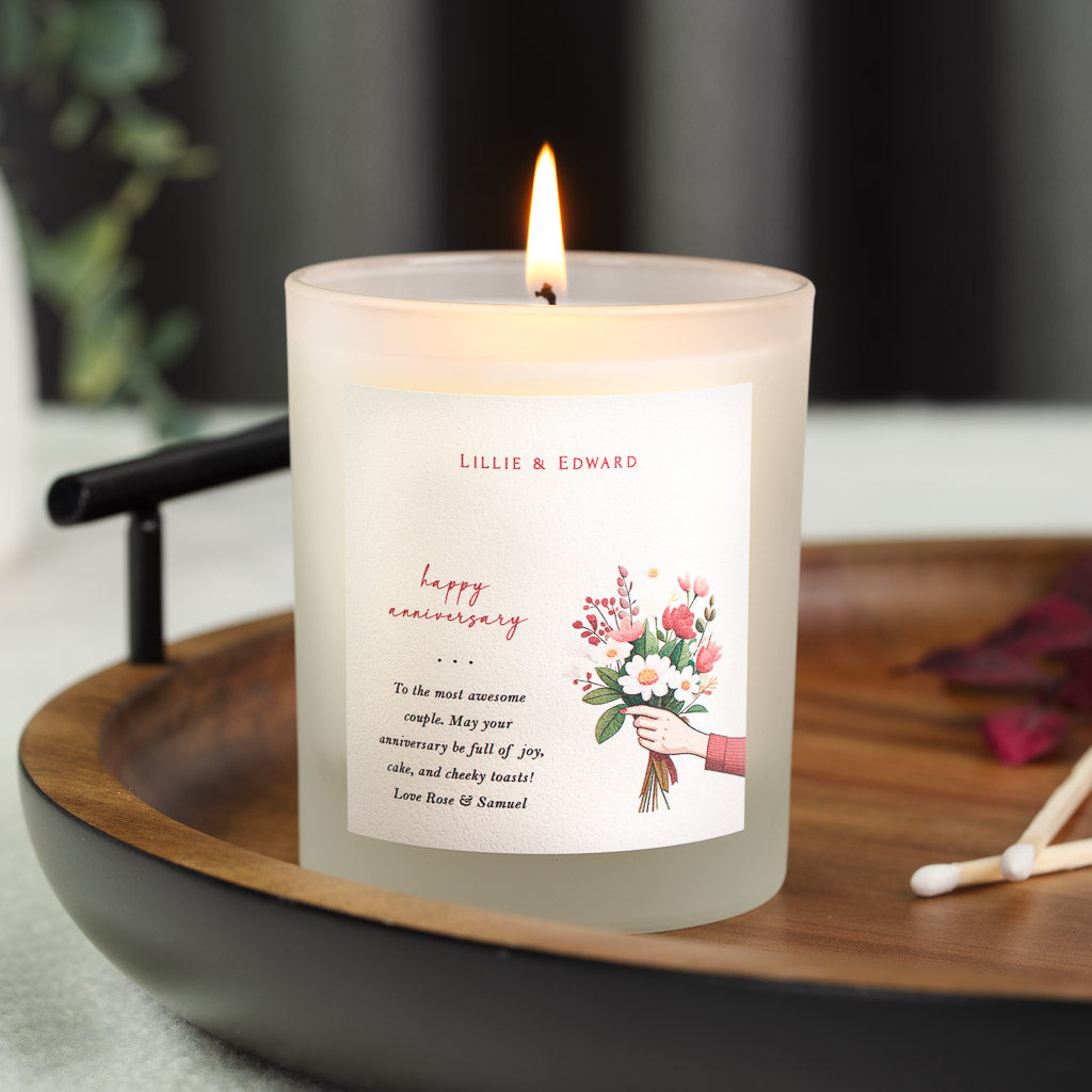 Hand-tied bouquet illustration set beside the lettering on a personalised anniversary candle