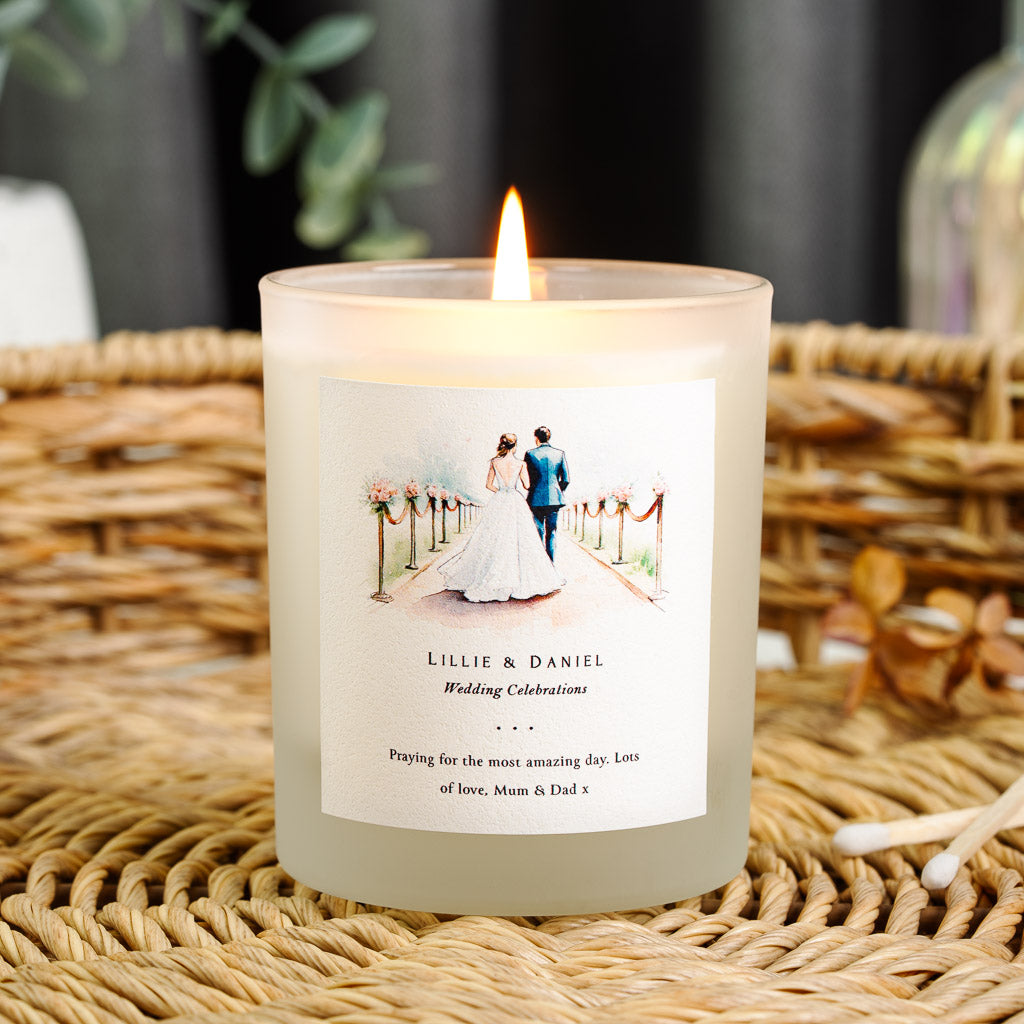 Personalised wedding candle with a watercolour couple walking a flower-lined aisle