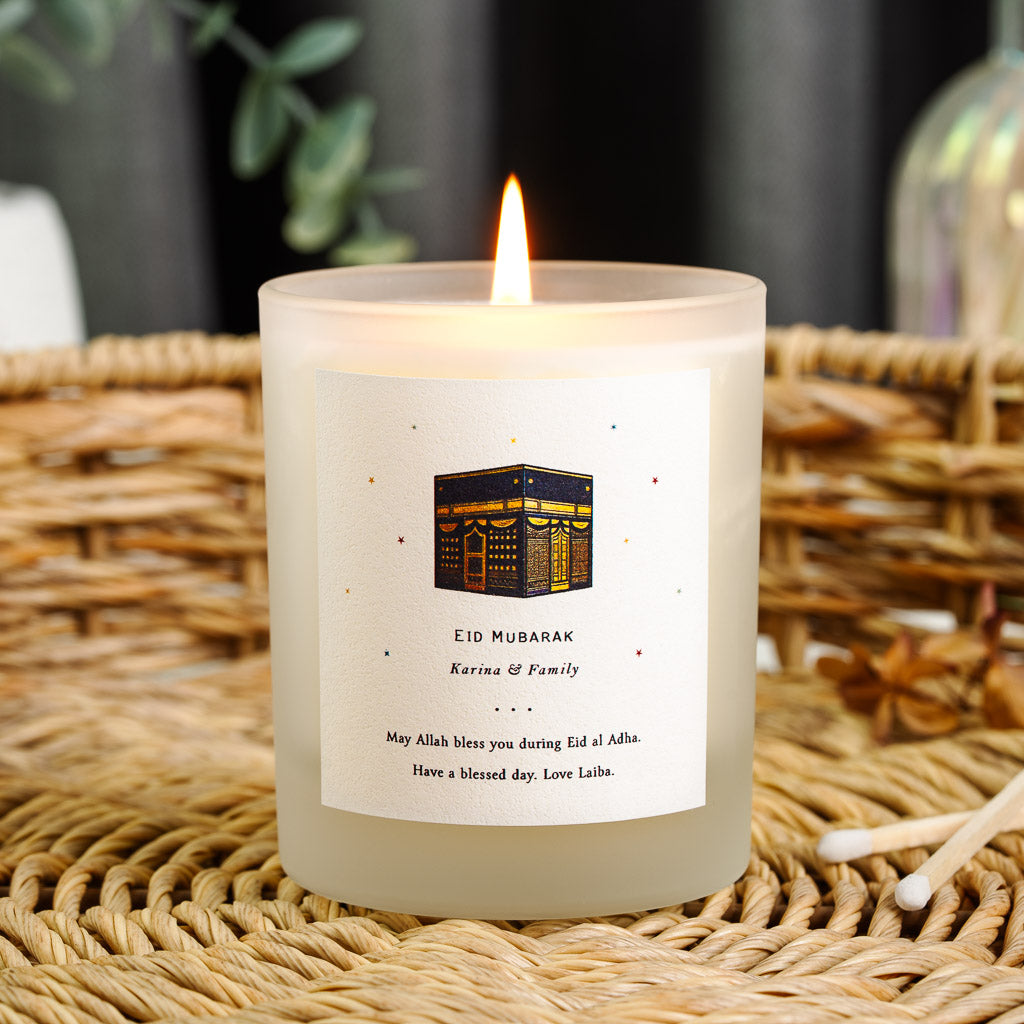 Personalised Eid candle with a warm gold and navy Kaaba surrounded by coloured details