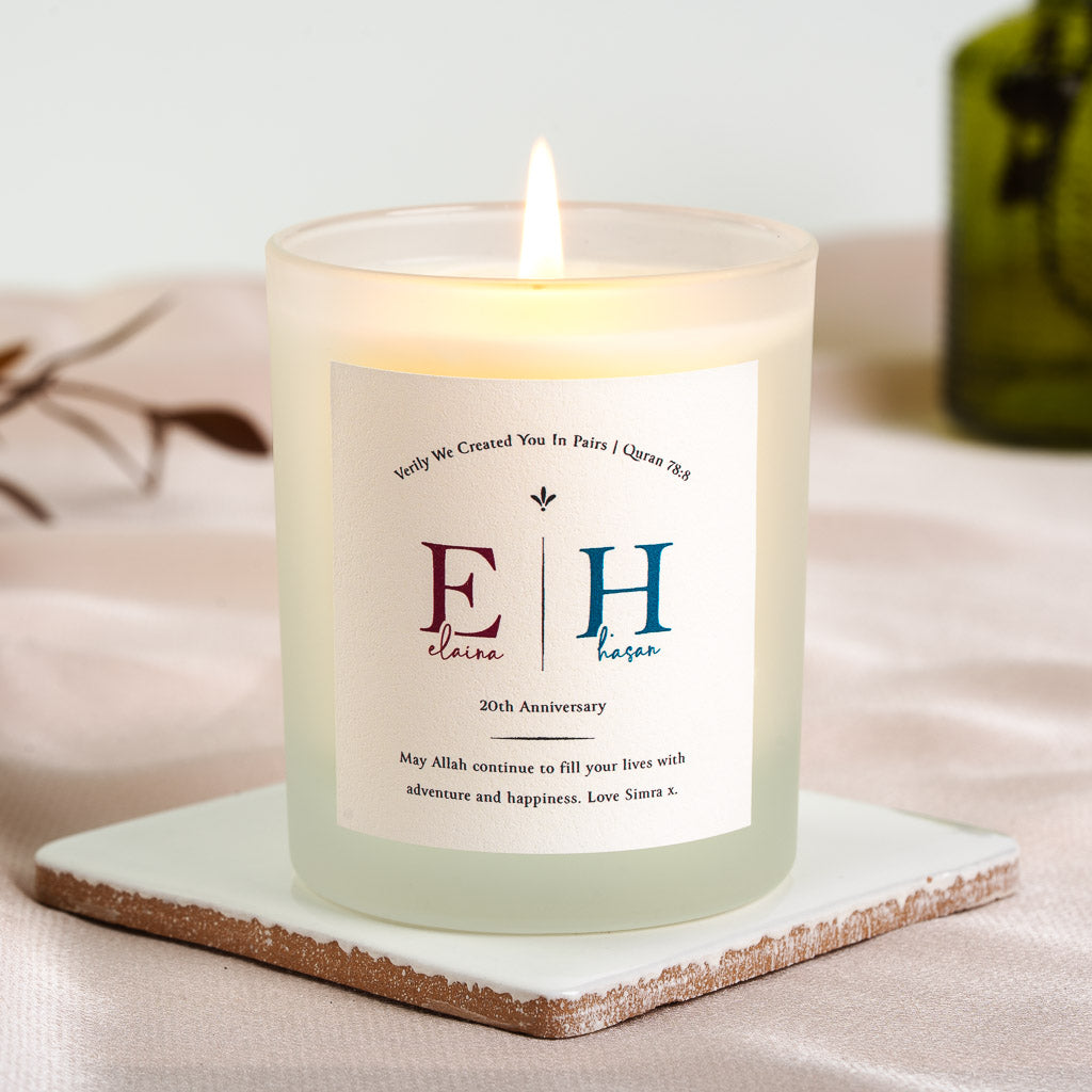 Personalised anniversary candle with the initials set large in maroon beneath a verse