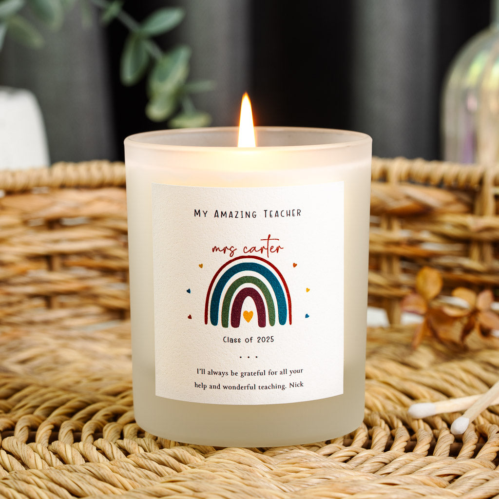 Deep red and teal rainbow arching over a small heart on a personalised teacher candle label