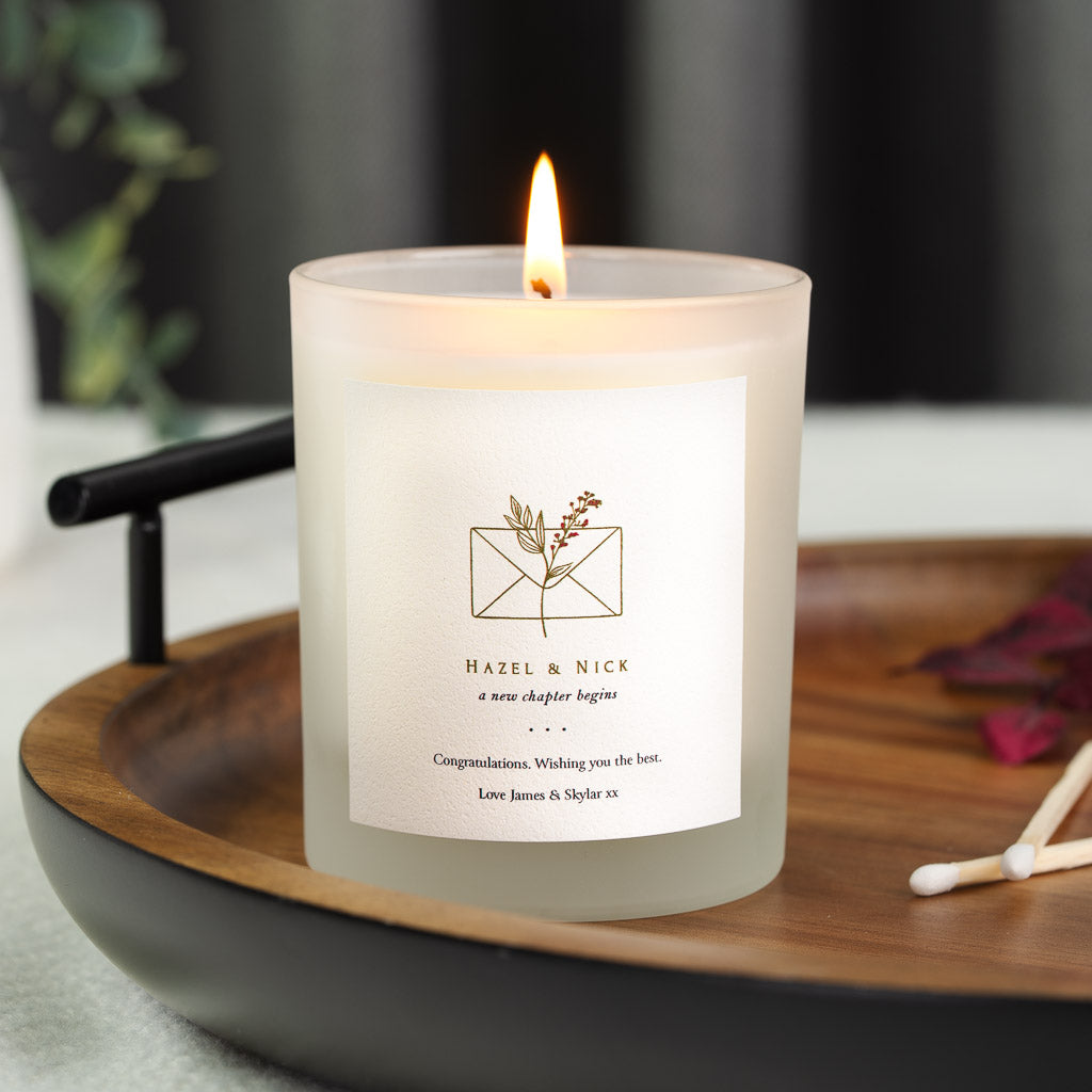 Line-drawn envelope above the couple's names on a personalised engagement candle label
