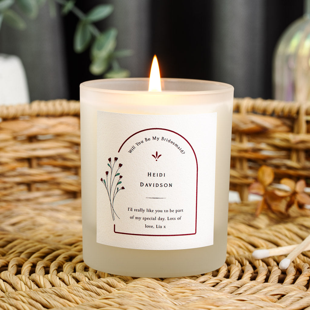 Personalised bridesmaid proposal candle with a deep maroon arch and a small floral motif