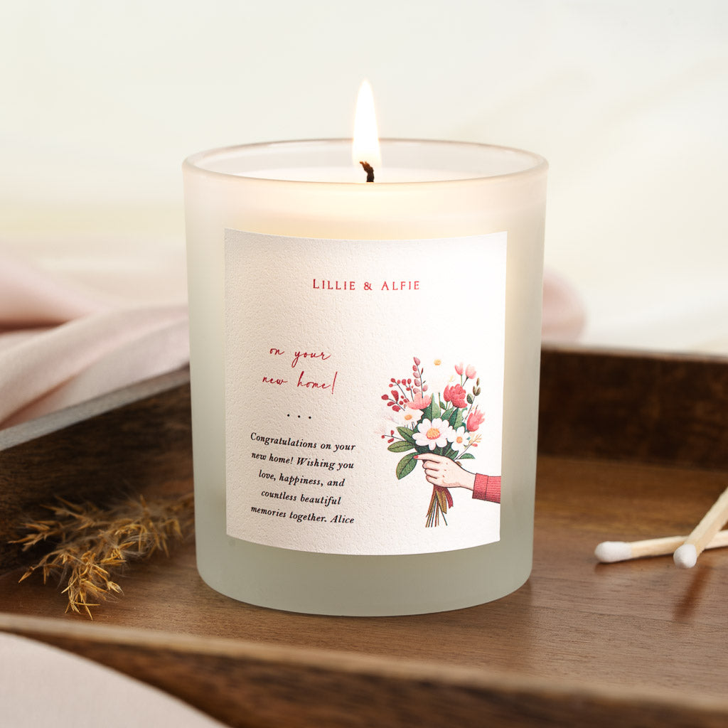 Bouquet illustration beside red script on a personalised new home candle label