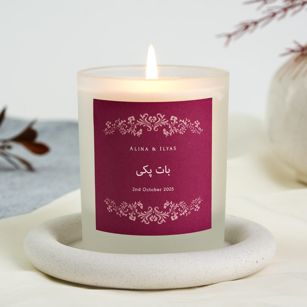 Personalised nikah candle with a pale pink ornamental border on a deep maroon label