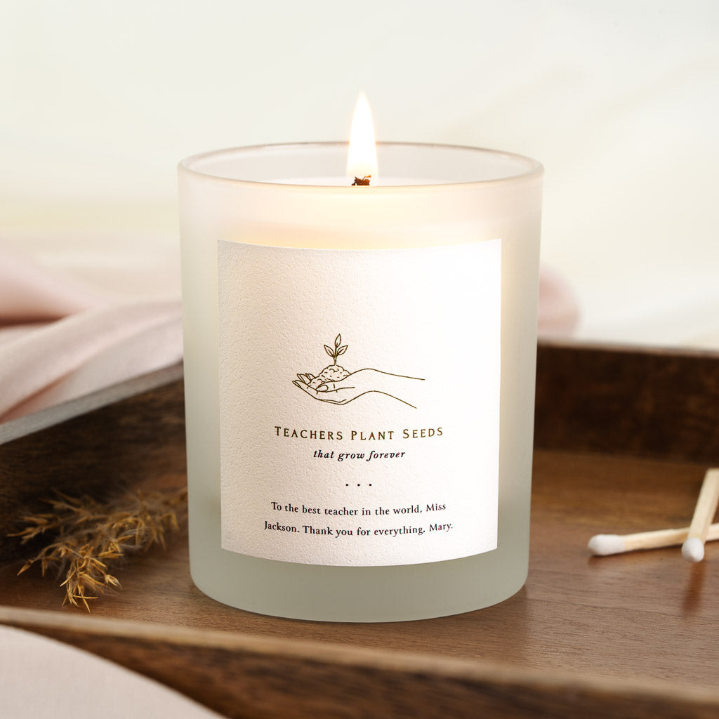 Personalised teacher candle with a line-drawn hand cupping a sprouting seedling
