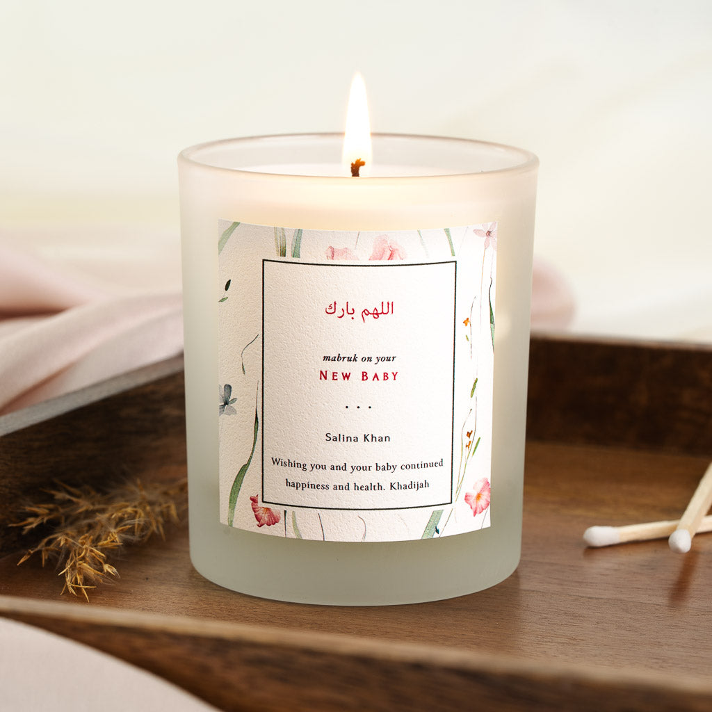Personalised Islamic new baby candle with pink and green floral sprigs around a boxed panel