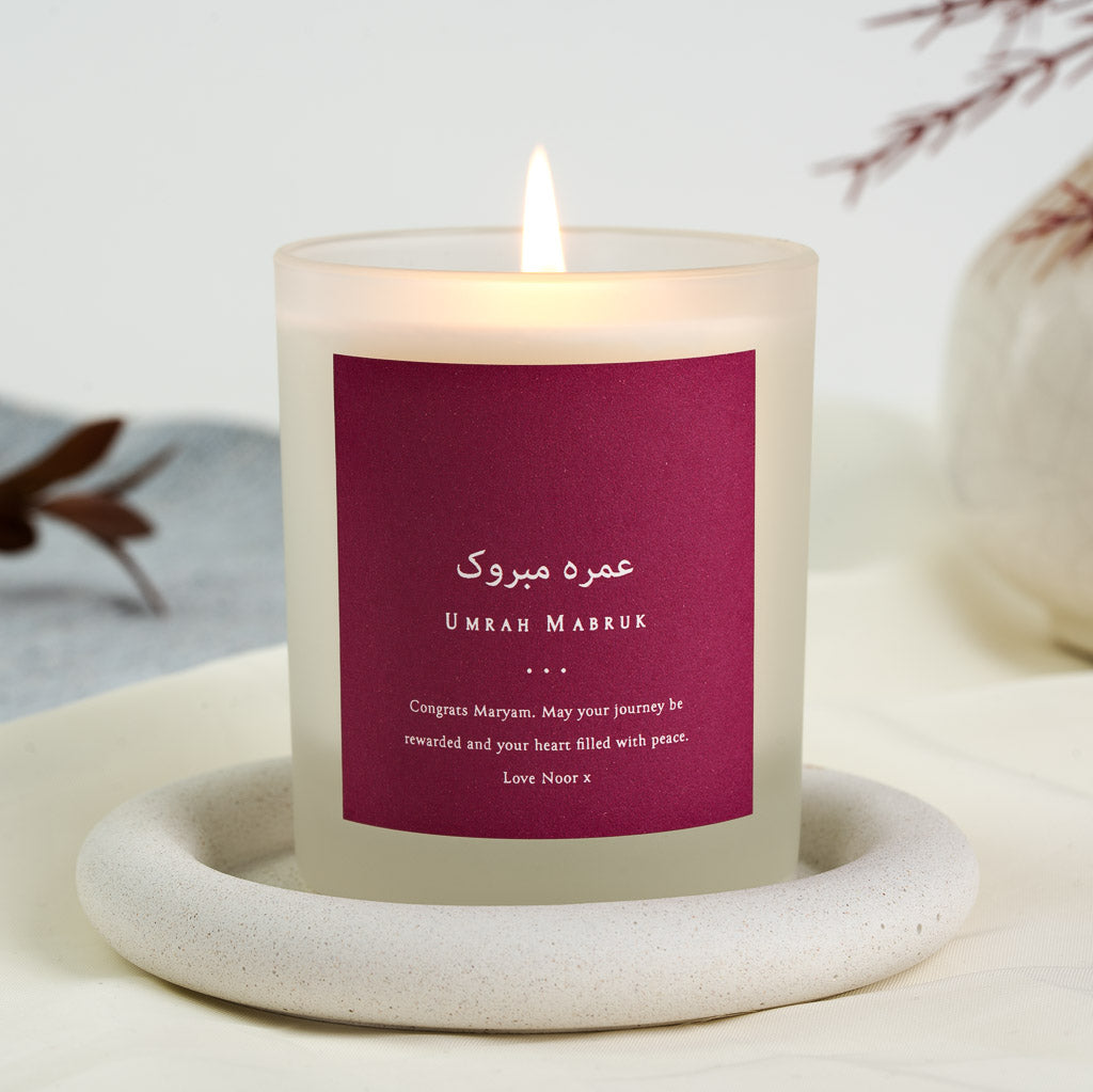 Personalised Umrah mabruk candle with white Arabic and English lettering on burgundy