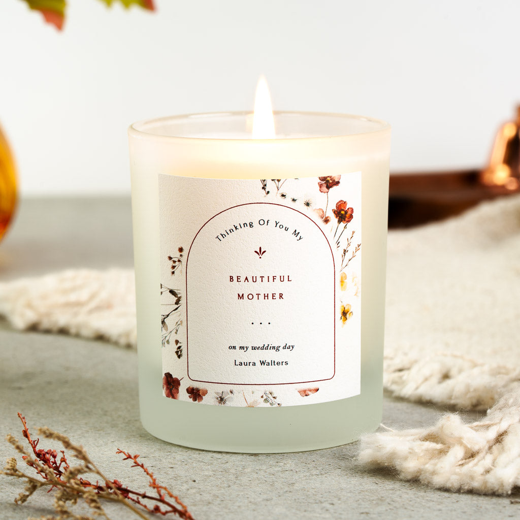 Autumnal florals framing an arched border on a personalised wedding day memorial candle