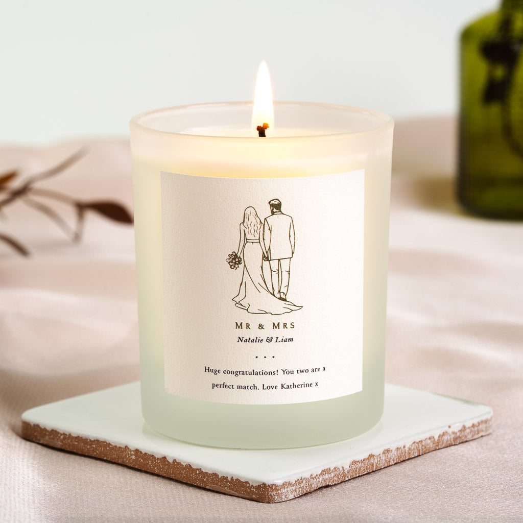 Walking couple illustration beneath Mr and Mrs on a personalised engagement candle label
