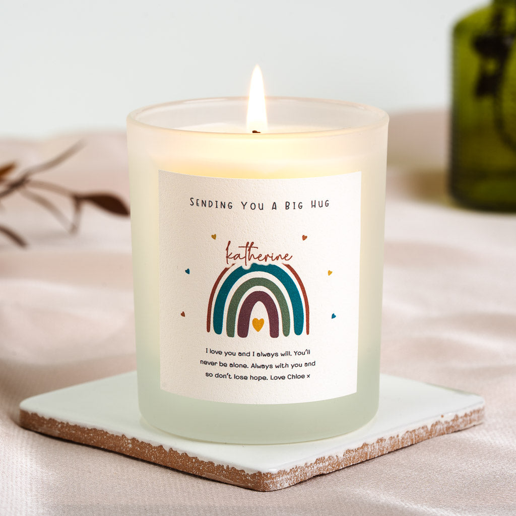 Rainbow illustration beneath the name in red script on a personalised get well candle label