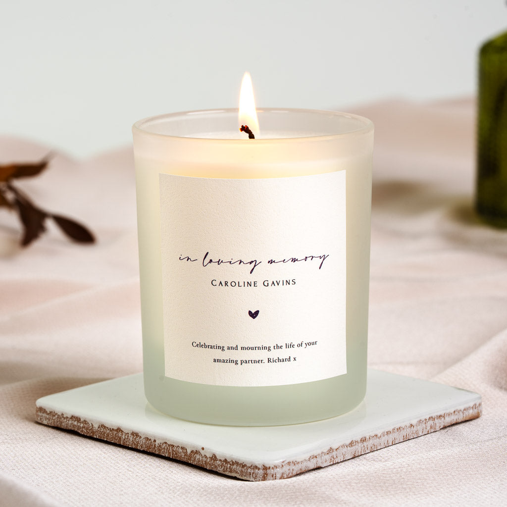 In loving memory in soft script above the name with a small heart on a personalised memorial candle