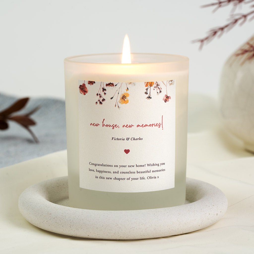 Personalised new home candle with red and orange florals above red script lettering