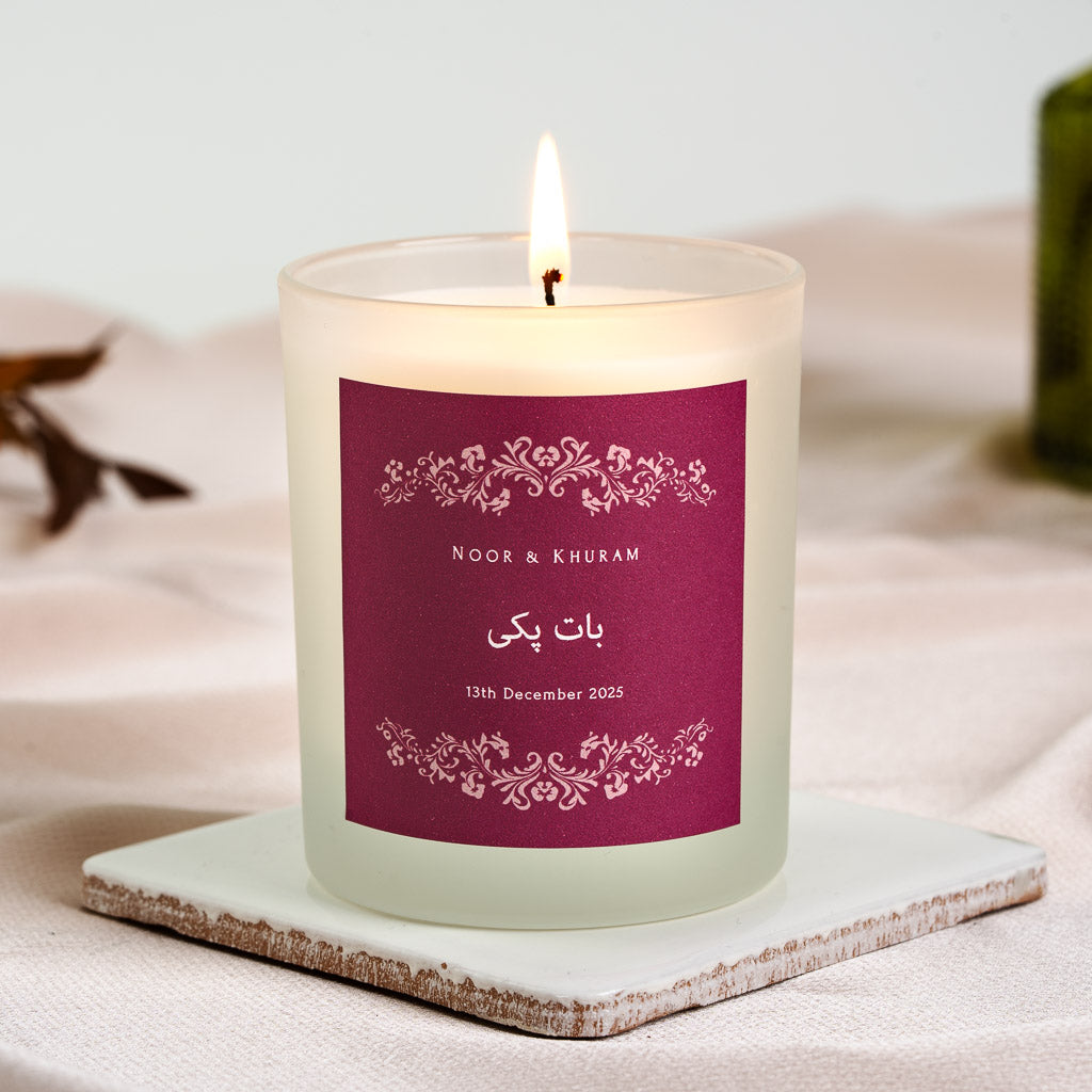 Personalised nikah candle with an ornate floral border on a deep berry panel